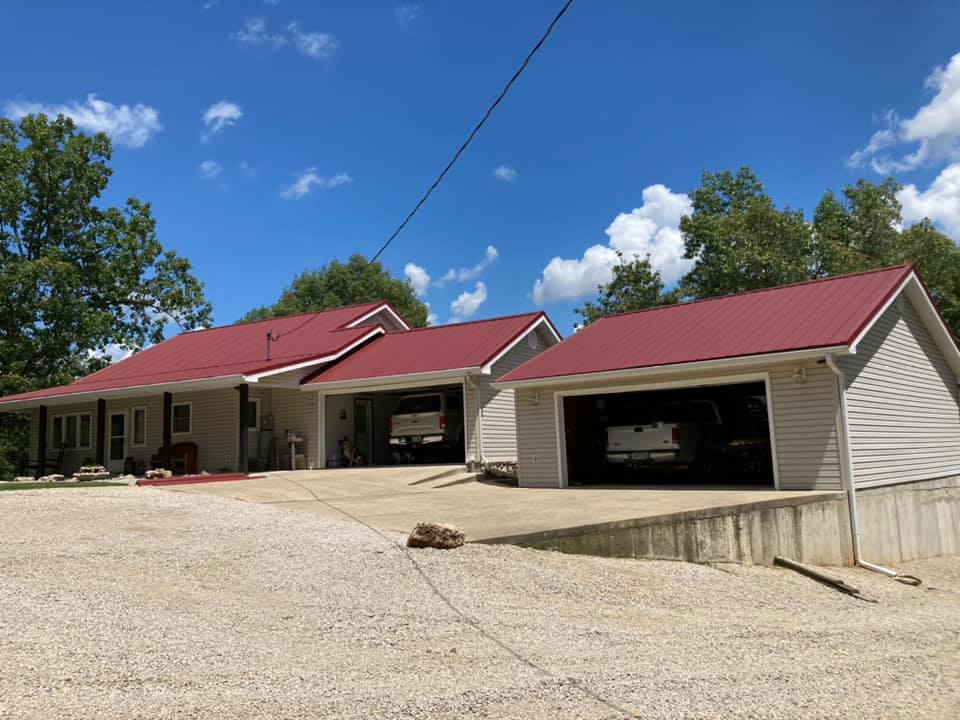red metal roof on garage and neighborhood home