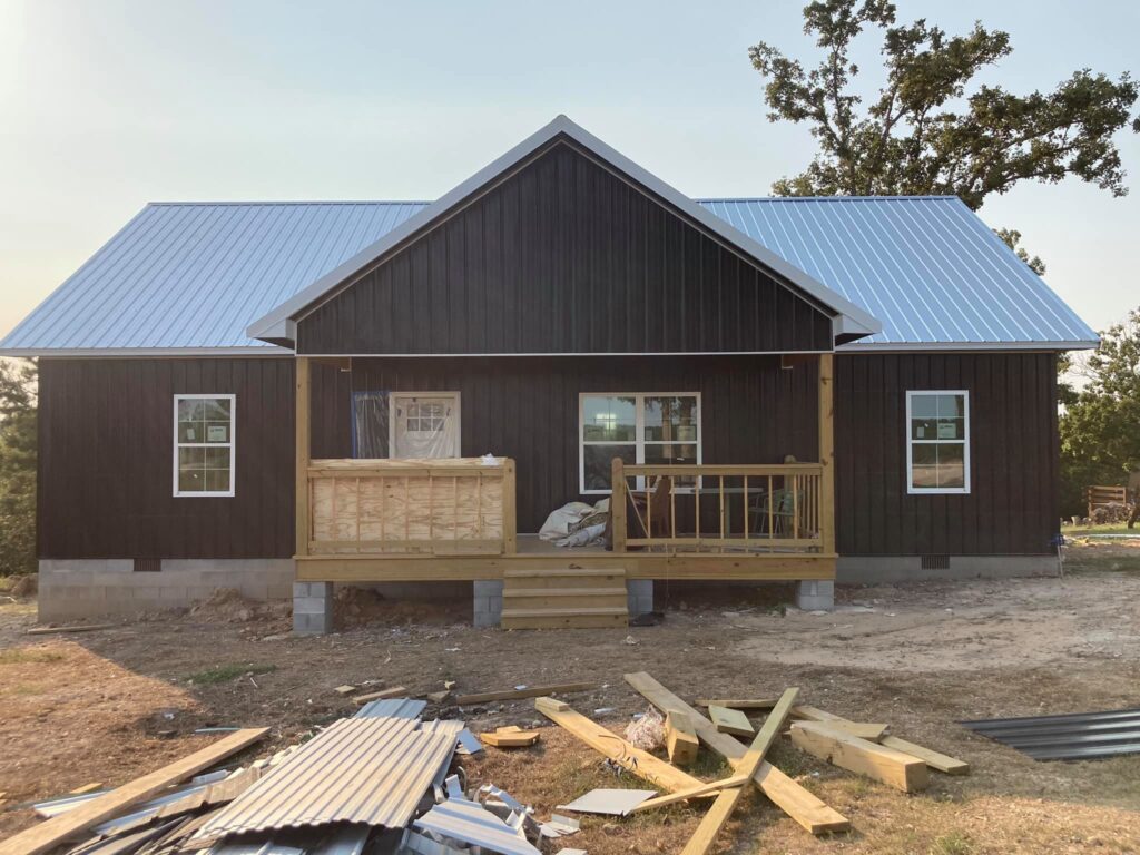 white metal roof on black new construction metal home
