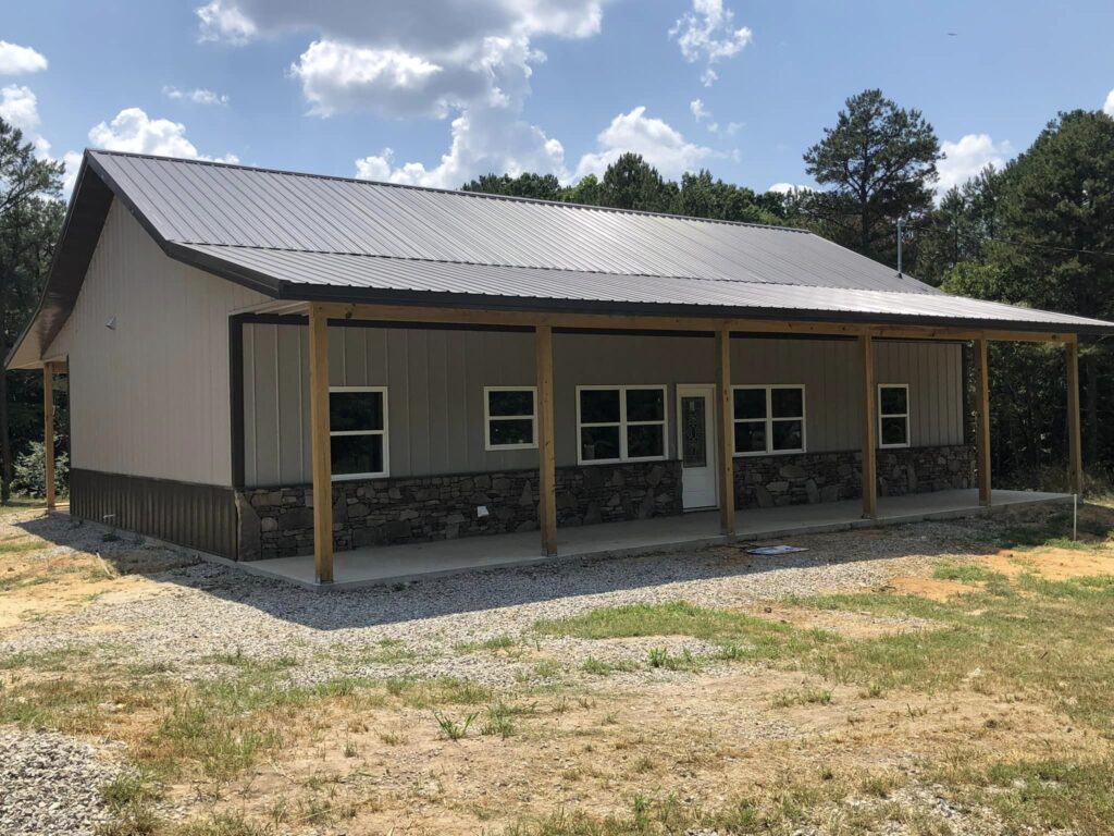 new construction metal home with rock porch