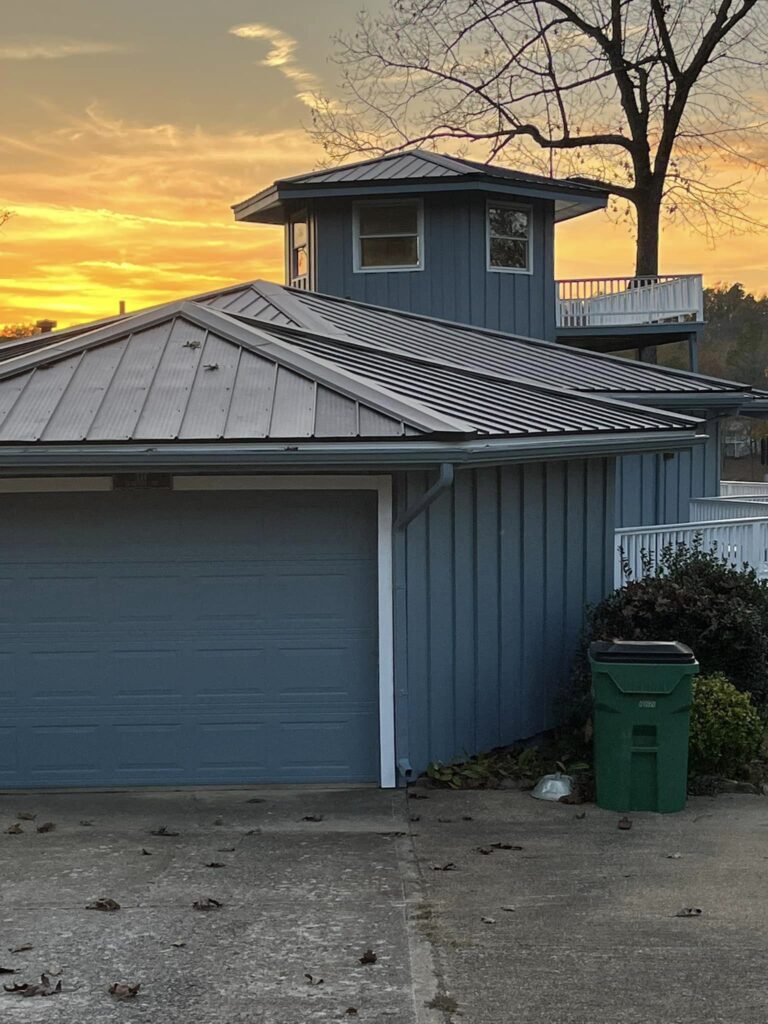 black metal roof on blue house