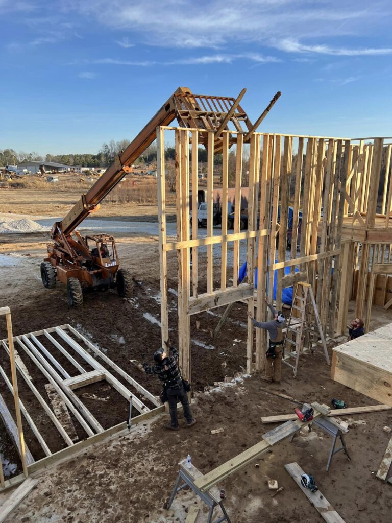 machine putting up two story walls