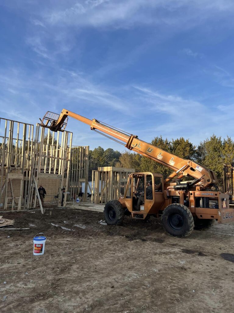 machine putting up house walls