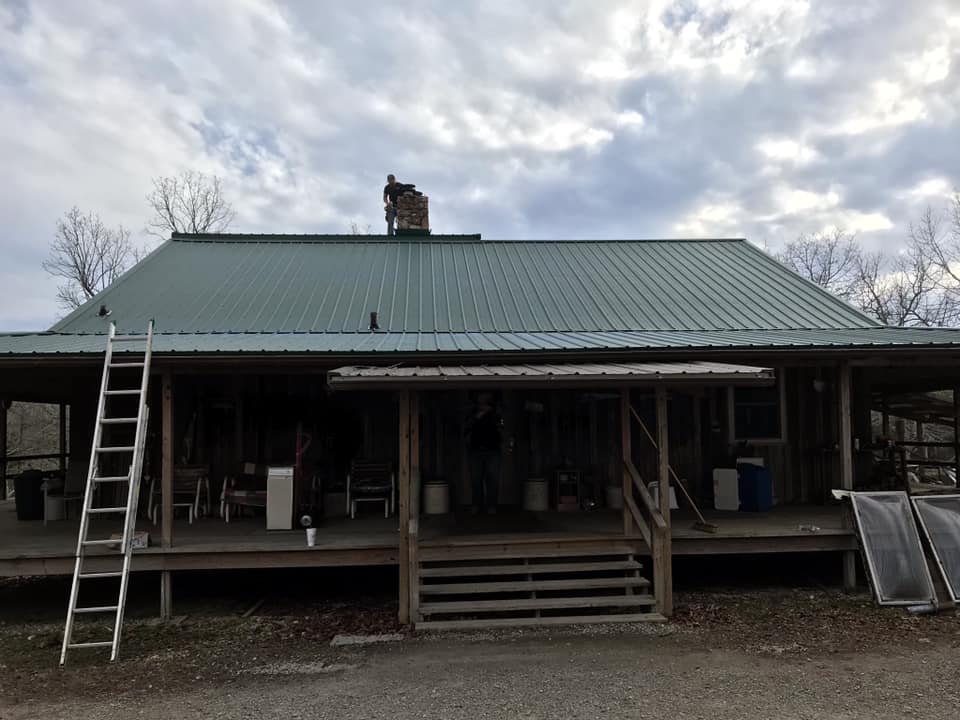 green metal roof on log style home