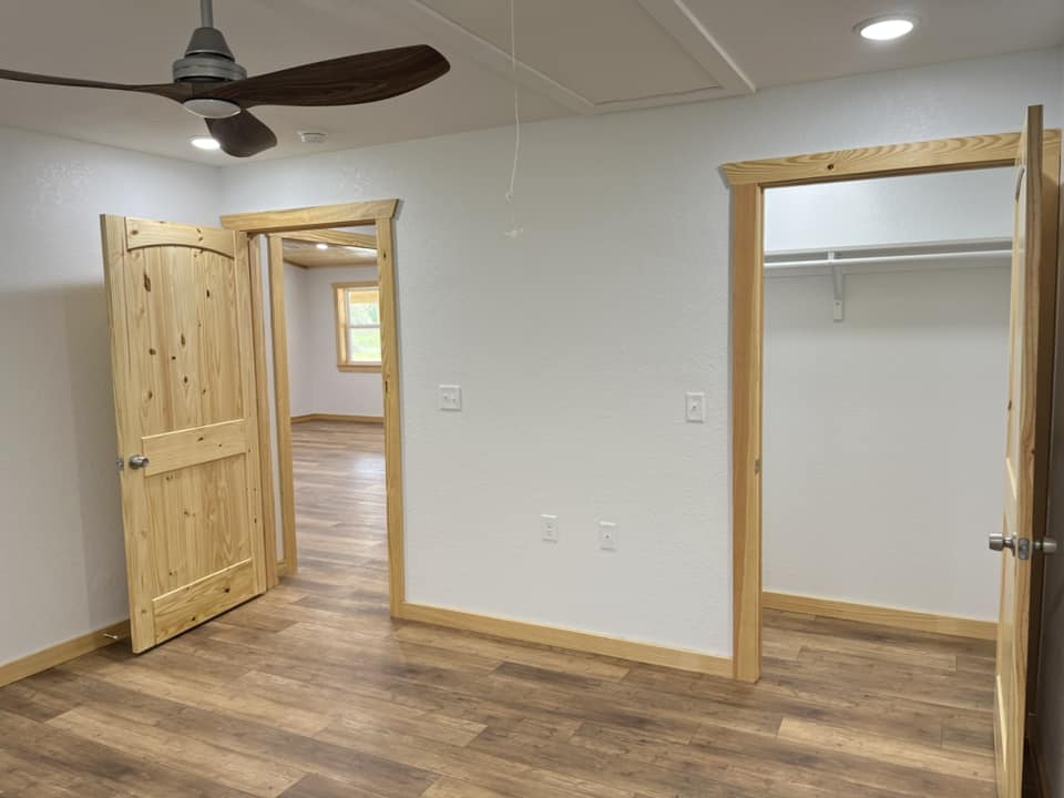 wooden bedroom and closet doors with wood trim