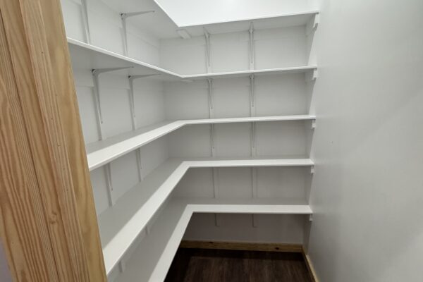 spacious walk in pantry with floor to ceiling shelves