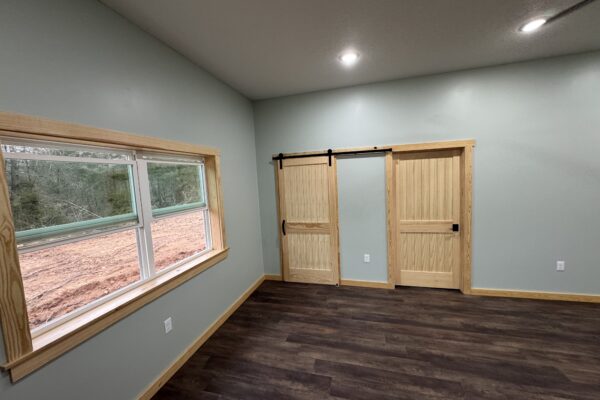 bedroom with attached bathroom and walk in closet