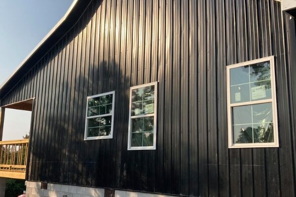 new construction home with black metal siding