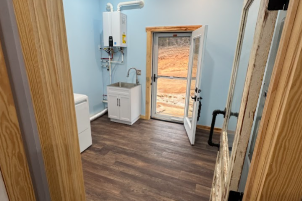 spacious laundry room with door to backyard